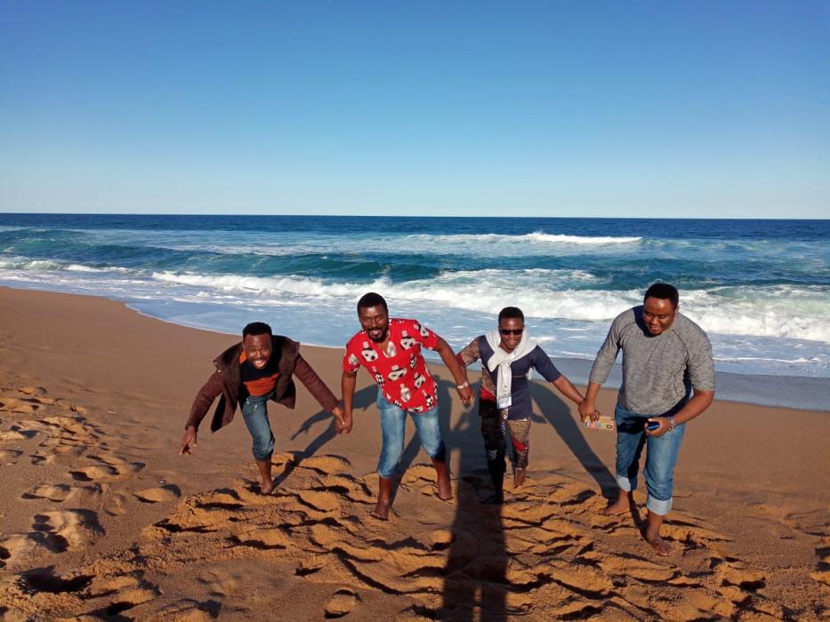 Paul, Tatenda, Adedotun and Stephen running away from the ocean tides Paul, Tatenda, Adedotun and Stephen running away from the ocean tides